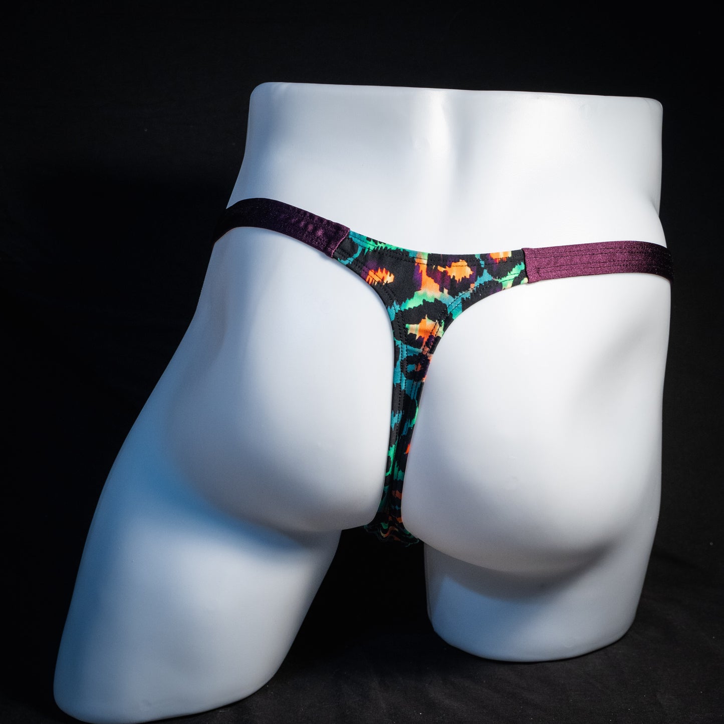 Men's green cheetah thong underwear, classic cut, rear view.