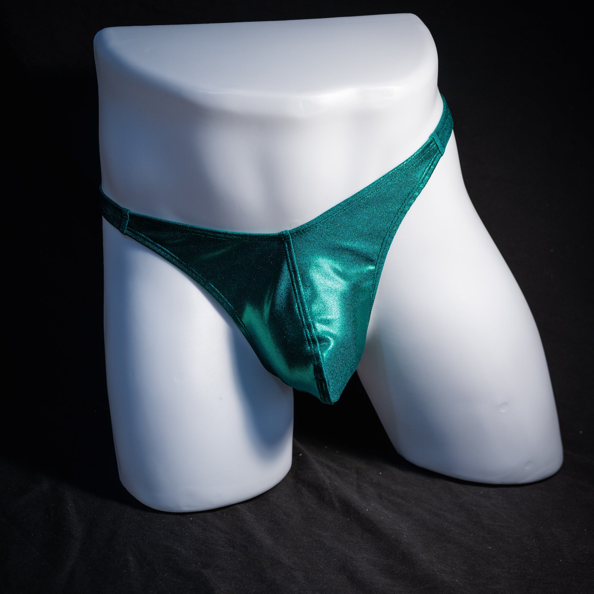 Men's green metallic thong underwear, classic cut, front view.