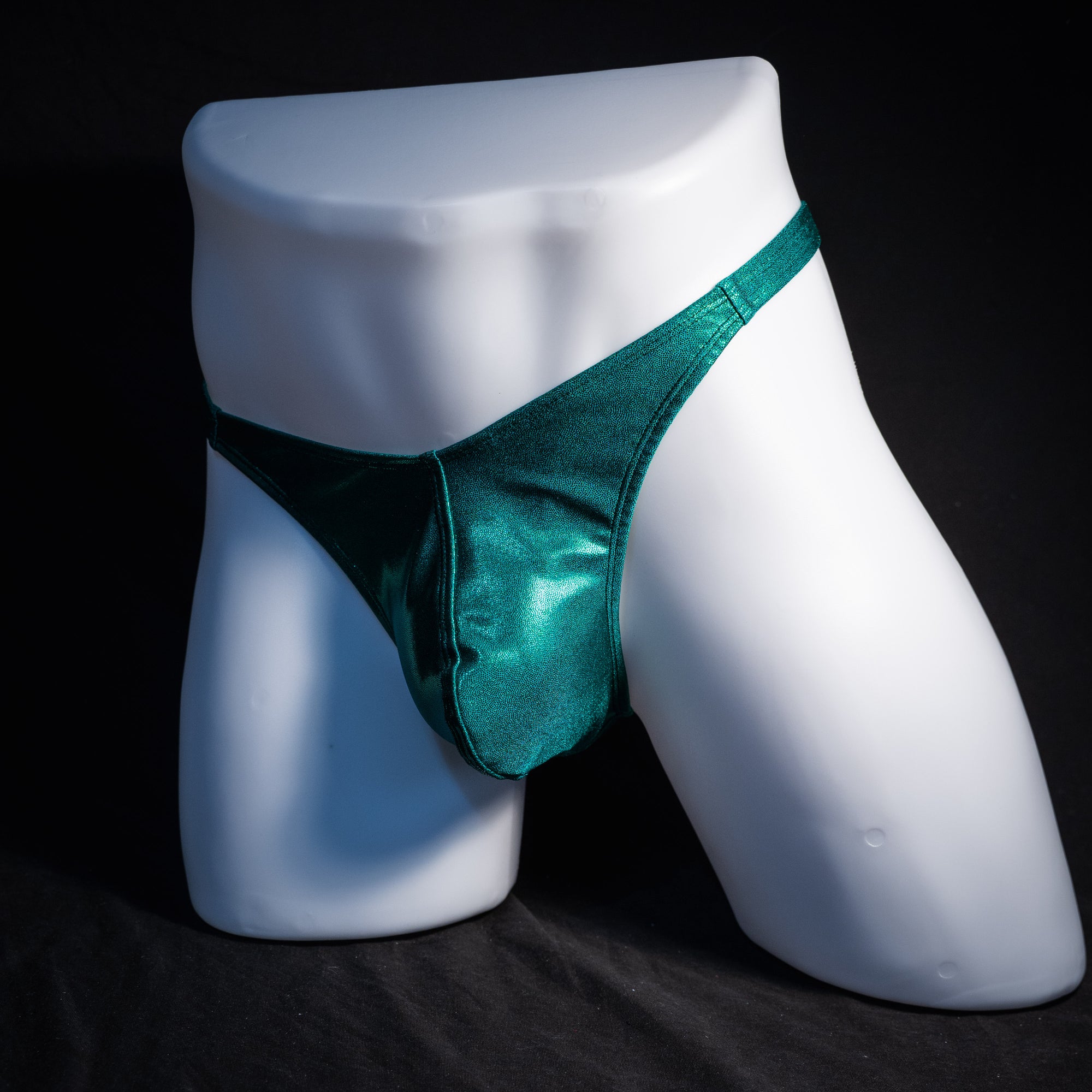 Men's green metallic thong underwear, classic cut, front view.