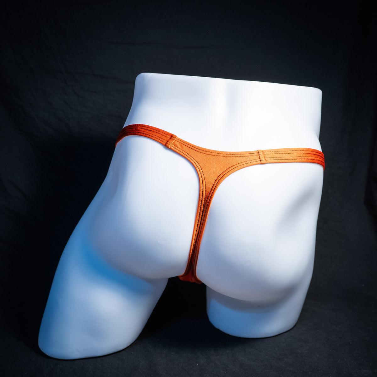Men's Halloween black and orange thong underwear, classic cut, rear view.