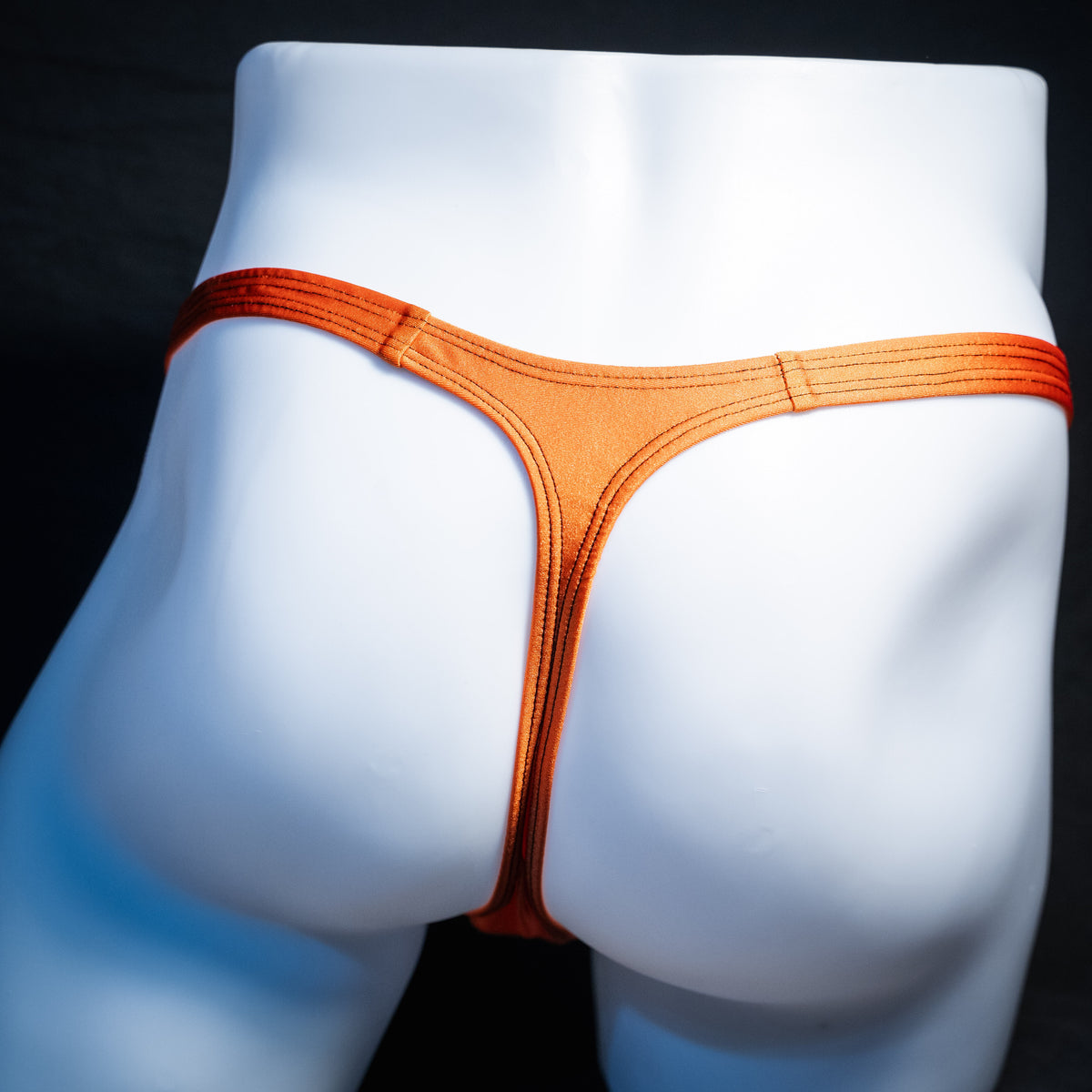 Men's Halloween black and orange thong underwear, classic cut, rear view.