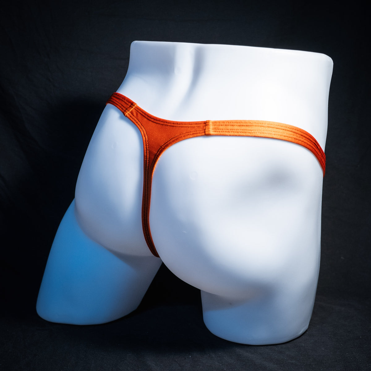 Men's Halloween black and orange thong underwear, classic cut, rear view.