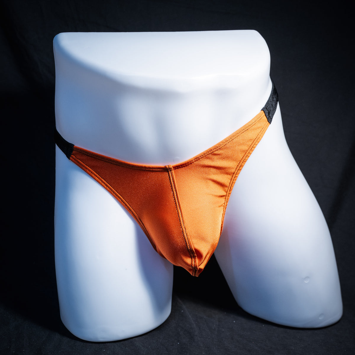 Men's Halloween orange and black thong underwear, classic cut, front view.
