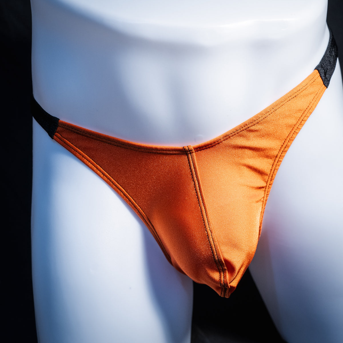 Men's Halloween orange and black thong underwear, classic cut, front view.