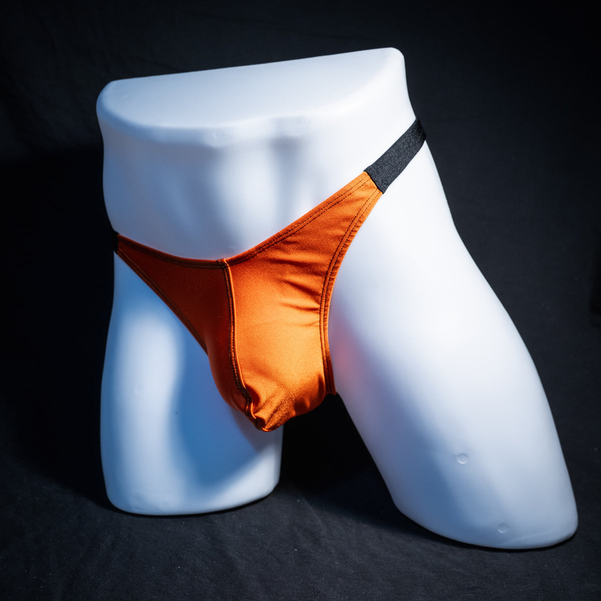 Men's Halloween orange and black thong underwear, classic cut, front view.