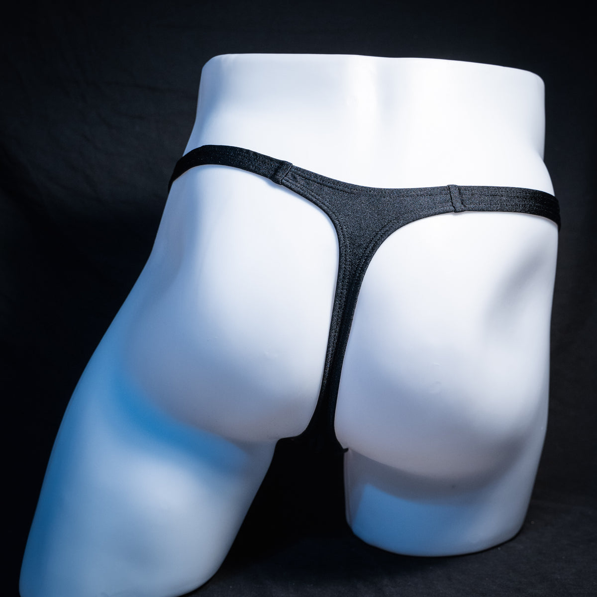 Men's Halloween orange and black thong underwear, classic cut, rear view.