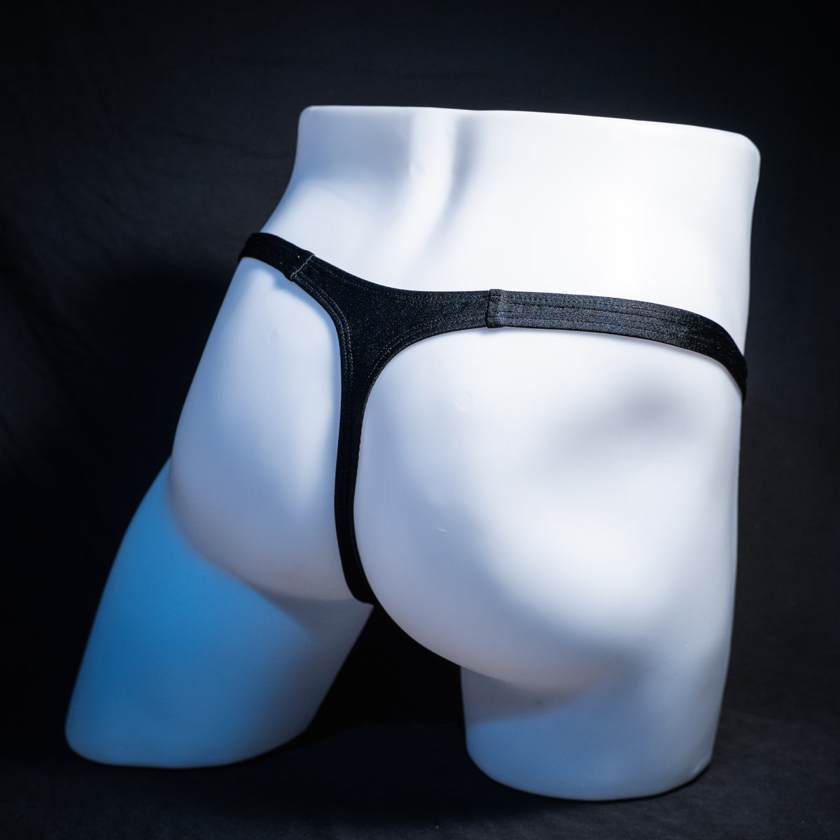 Men's Halloween orange and black thong underwear, classic cut, rear view.