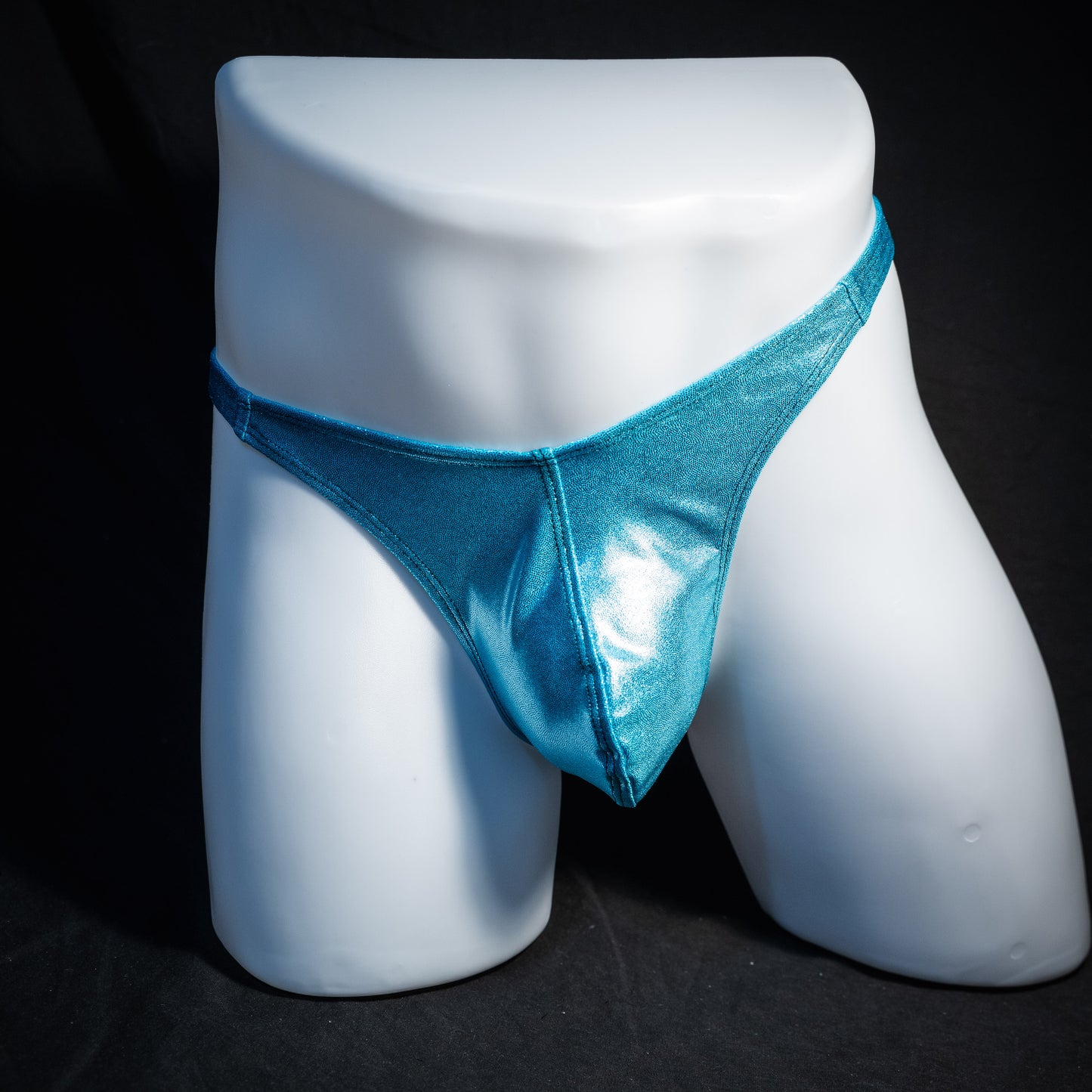 Men's metallic Hawaiian baby blue thong underwear, classic cut, front view.