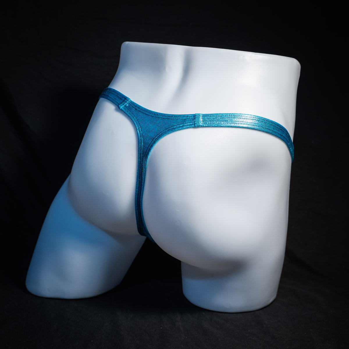 Men's metallic Hawaiian baby blue thong underwear, classic cut, rear view.