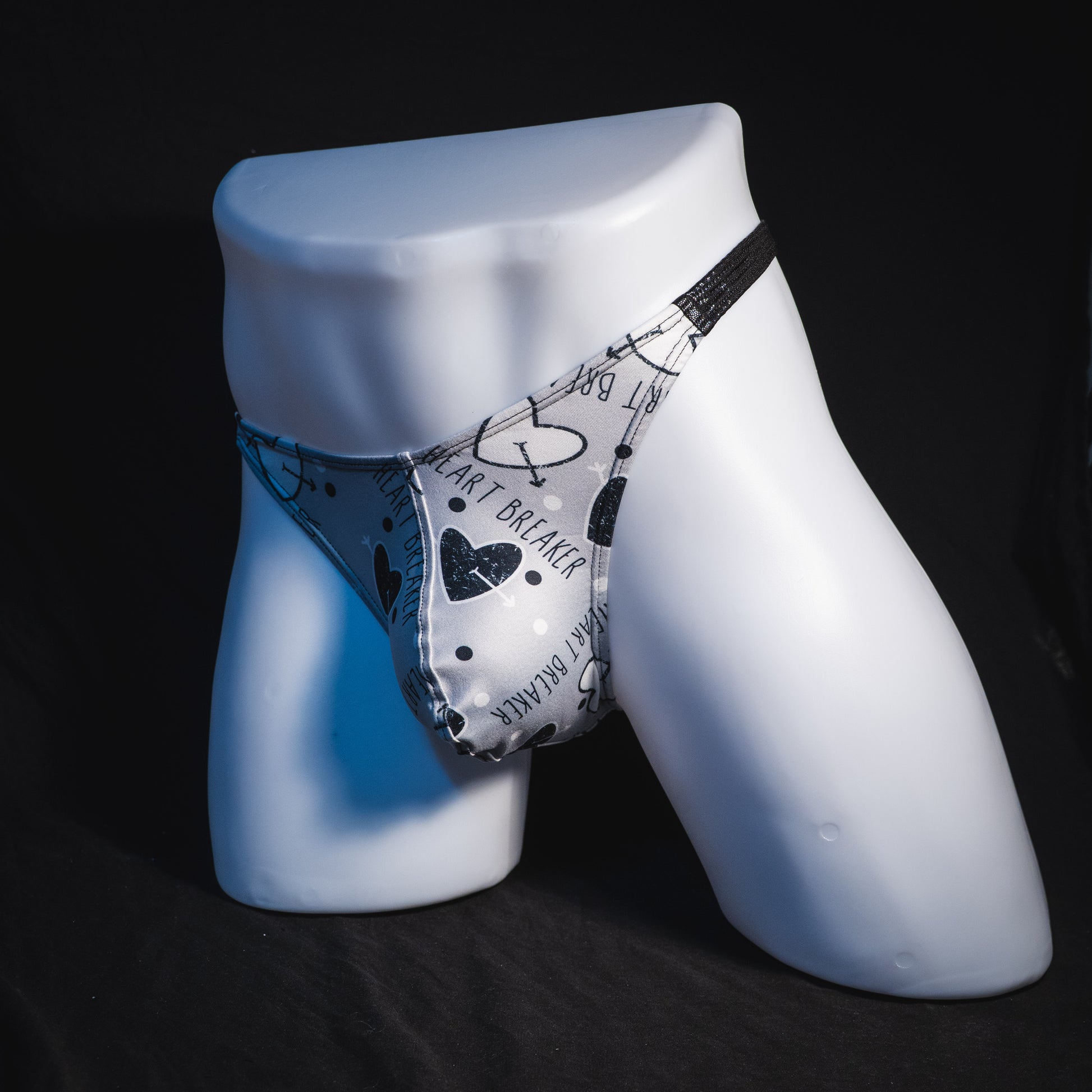 Men's black and white Valentine's Day thong underwear, Classic cut, full front angled view.