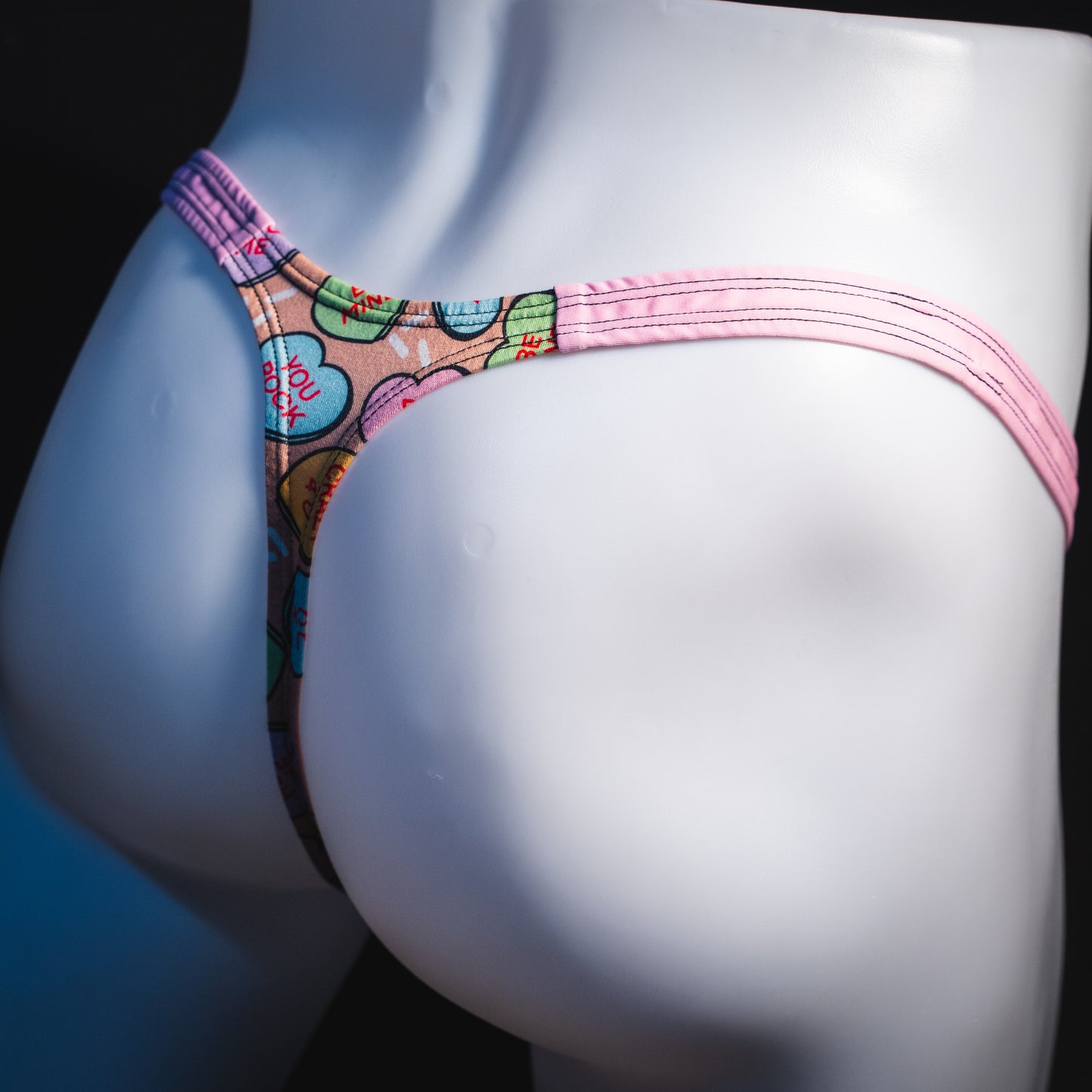 Men's Valentine Day Heart candies thong Underwear, Classic cut, rear angled view.