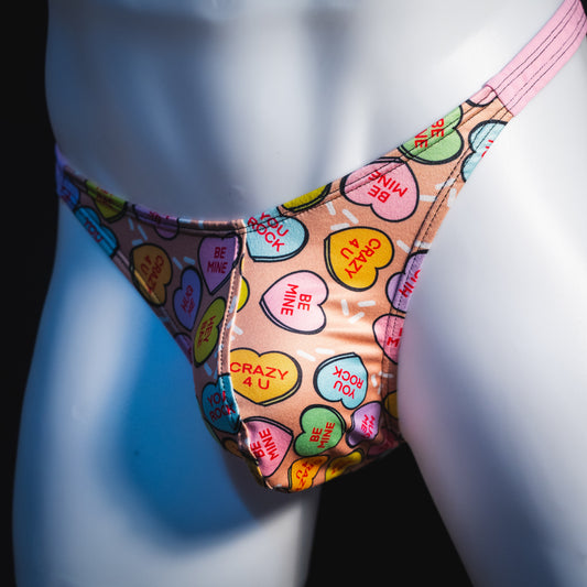 Men's Valentine Day Heart candies thong Underwear, Classic cut, angled front view.