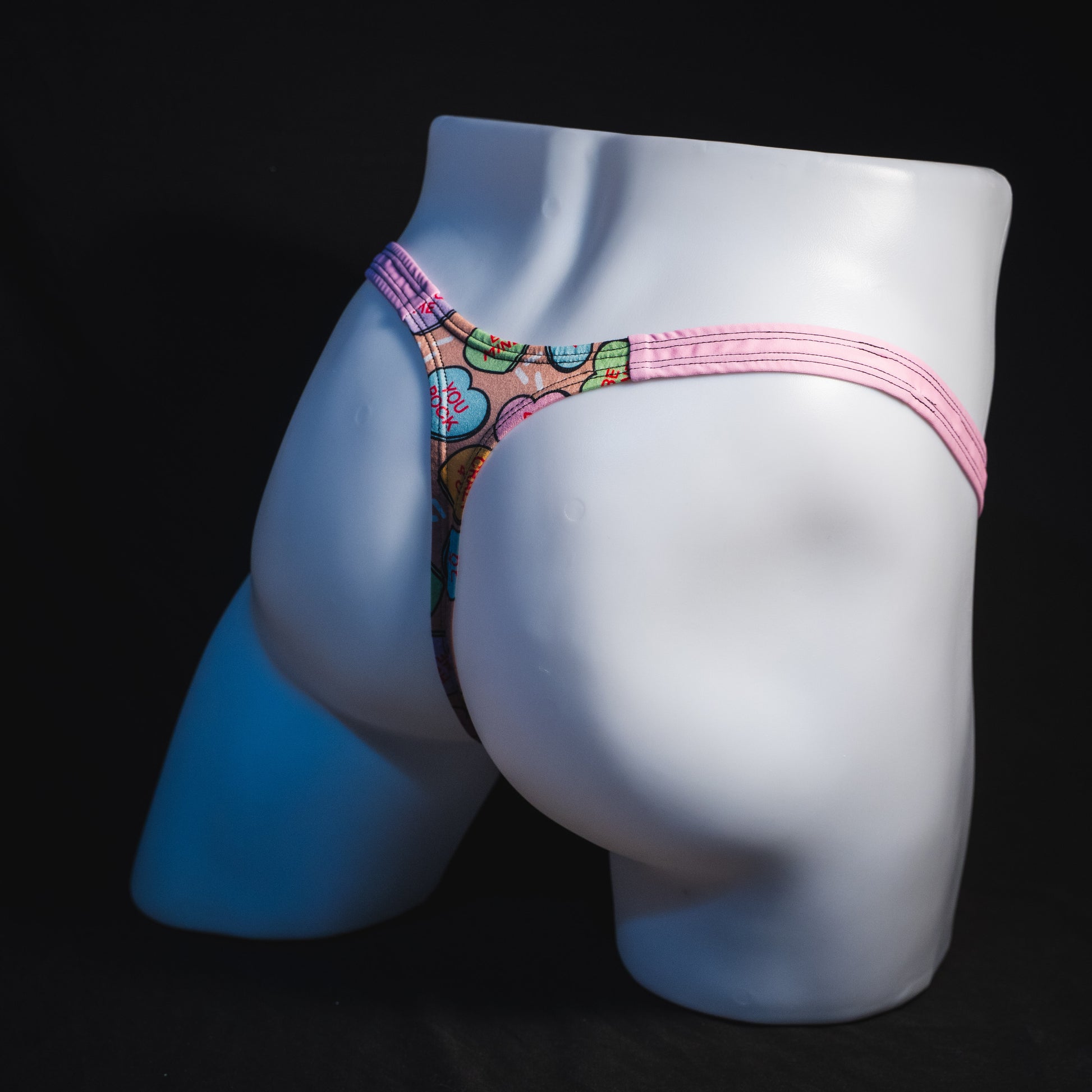 Men's Valentine Day Heart candies thong Underwear, Classic cut, Full angled rear view.