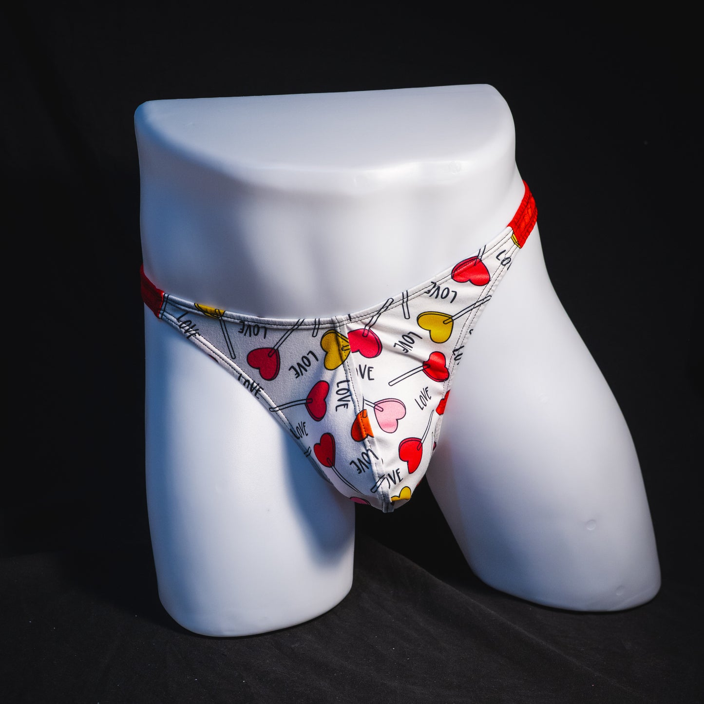 Men's heart shaped lollipops thong underwear, classic cut, full front view.