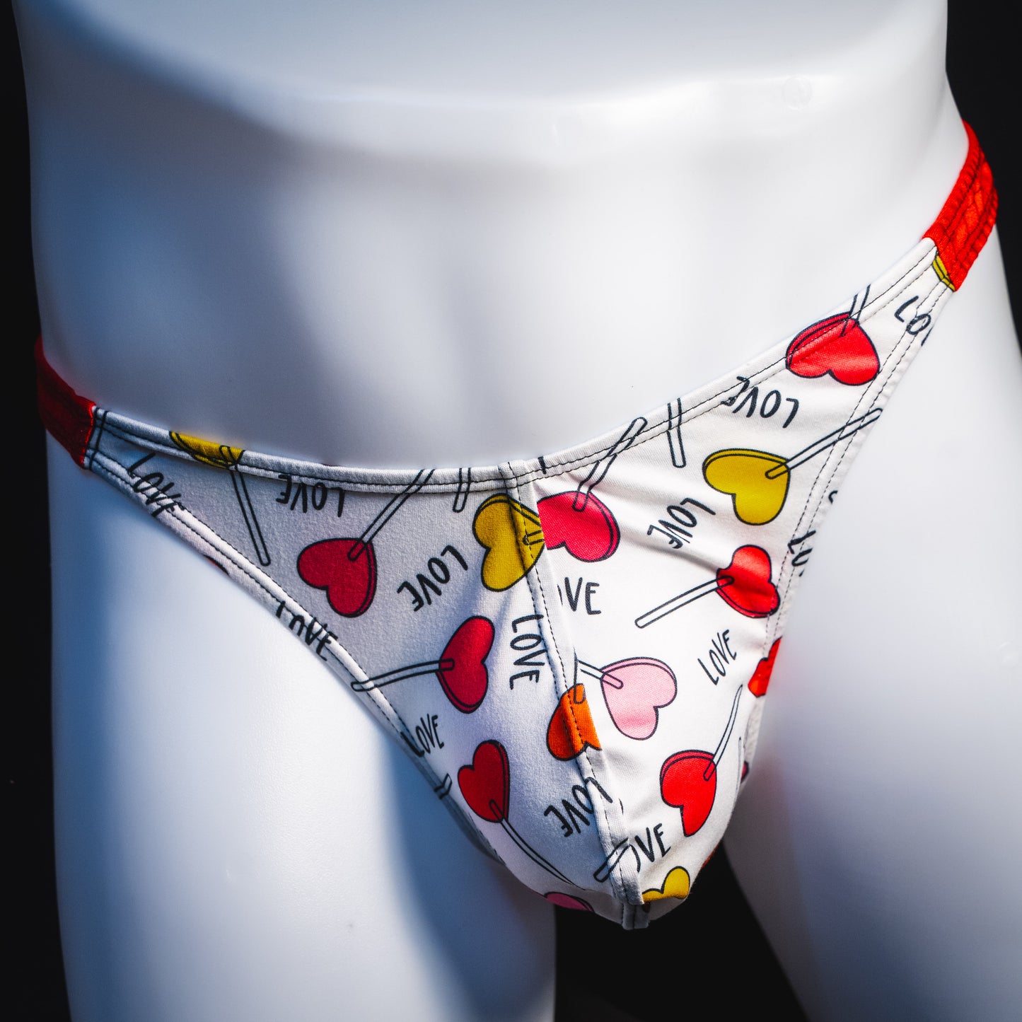 Men's heart shaped lollipops thong underwear, classic cut, front view.