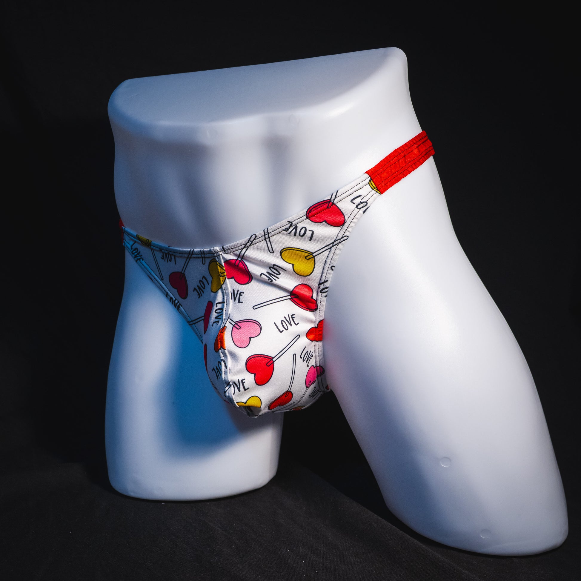 Men's heart shaped lollipops thong underwear, classic cut, full angled front view.