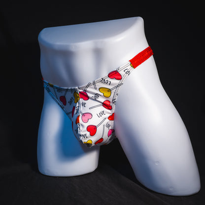Men's heart shaped lollipops thong underwear, classic cut, full angled front view.