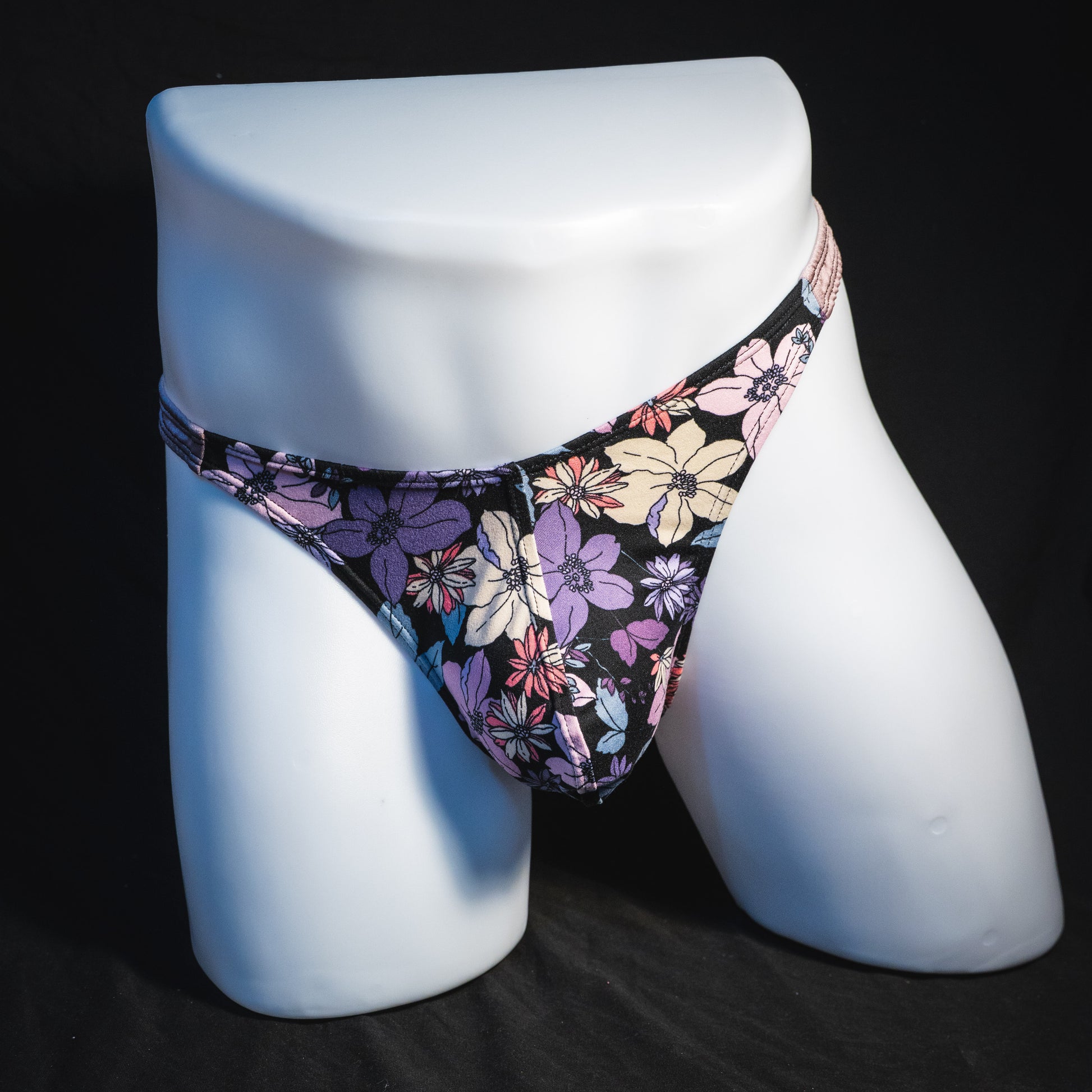 Men's purple floral with lilac straps thong underwear, classic cut, full front view.