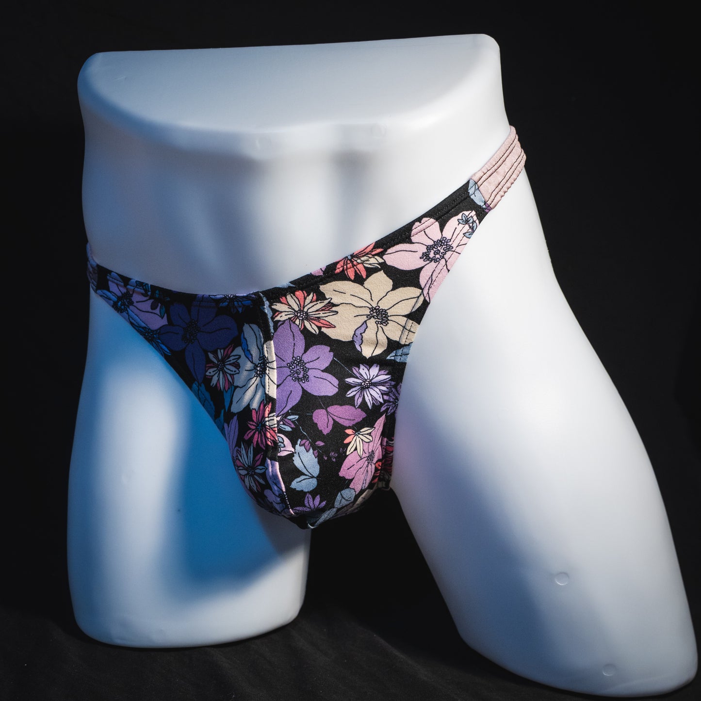 Men's purple floral with lilac straps thong underwear, classic cut, full angled front view.