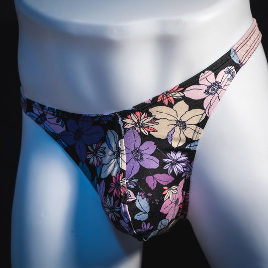 Men's purple floral with lilac straps thong underwear, classic cut, angled front view.