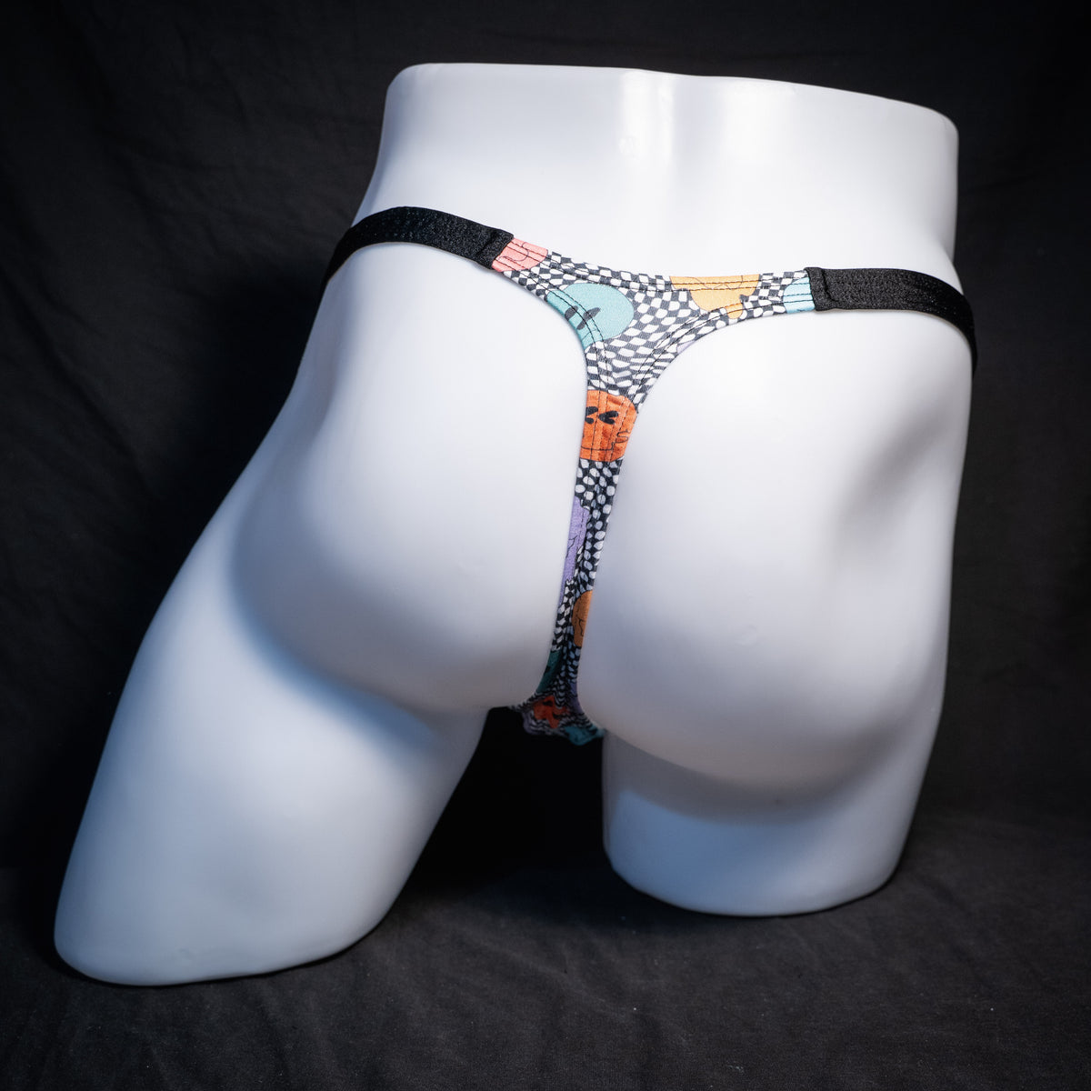 Men's melting faces thong underwear, classic cut, rear view.