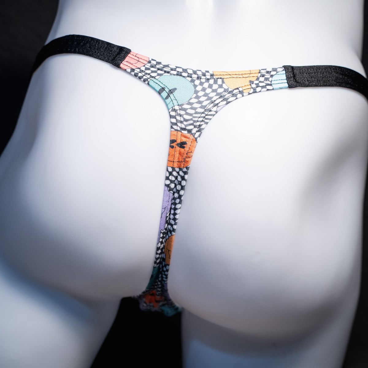 Men's melting faces thong underwear, classic cut, rear view.