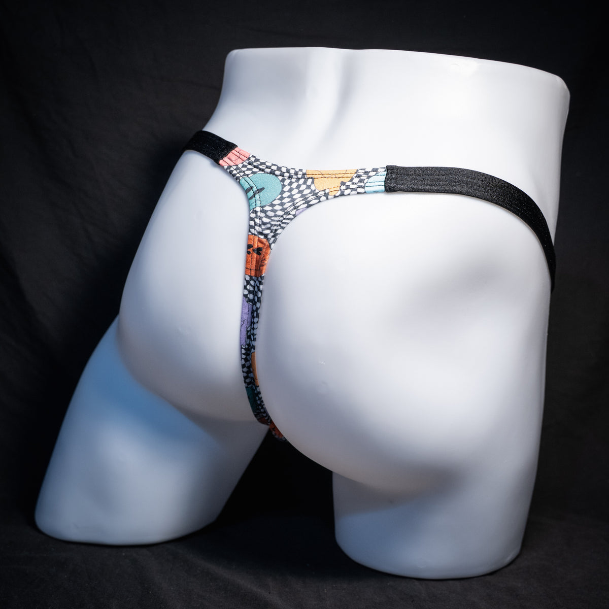 Men's melting faces thong underwear, classic cut, rear view.
