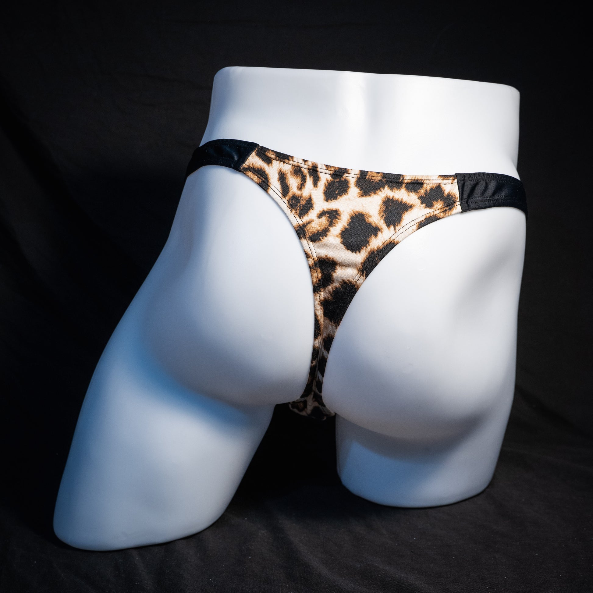 Men's mesh and cheetah print thong underwear, slim cut, rear view.