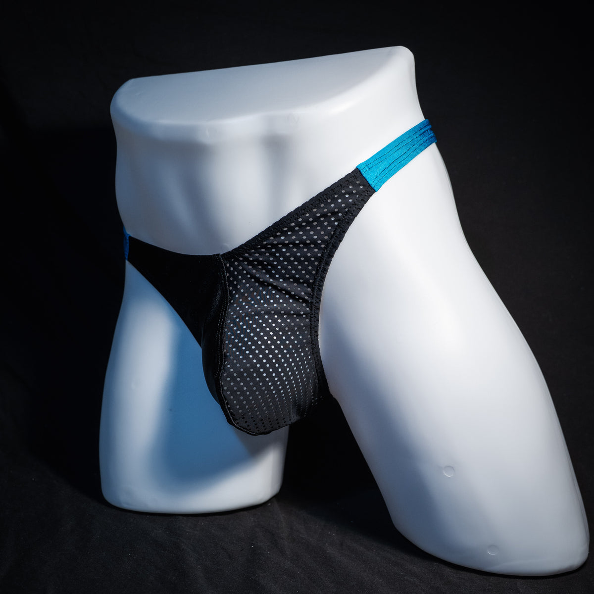 Men's black mesh and teal thong underwear, classic cut, front view.