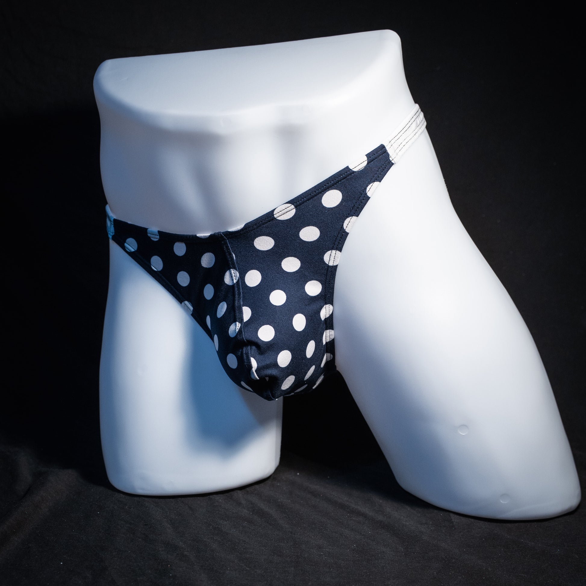 Men's navy blue and white thong underwear, classic cut, front view.