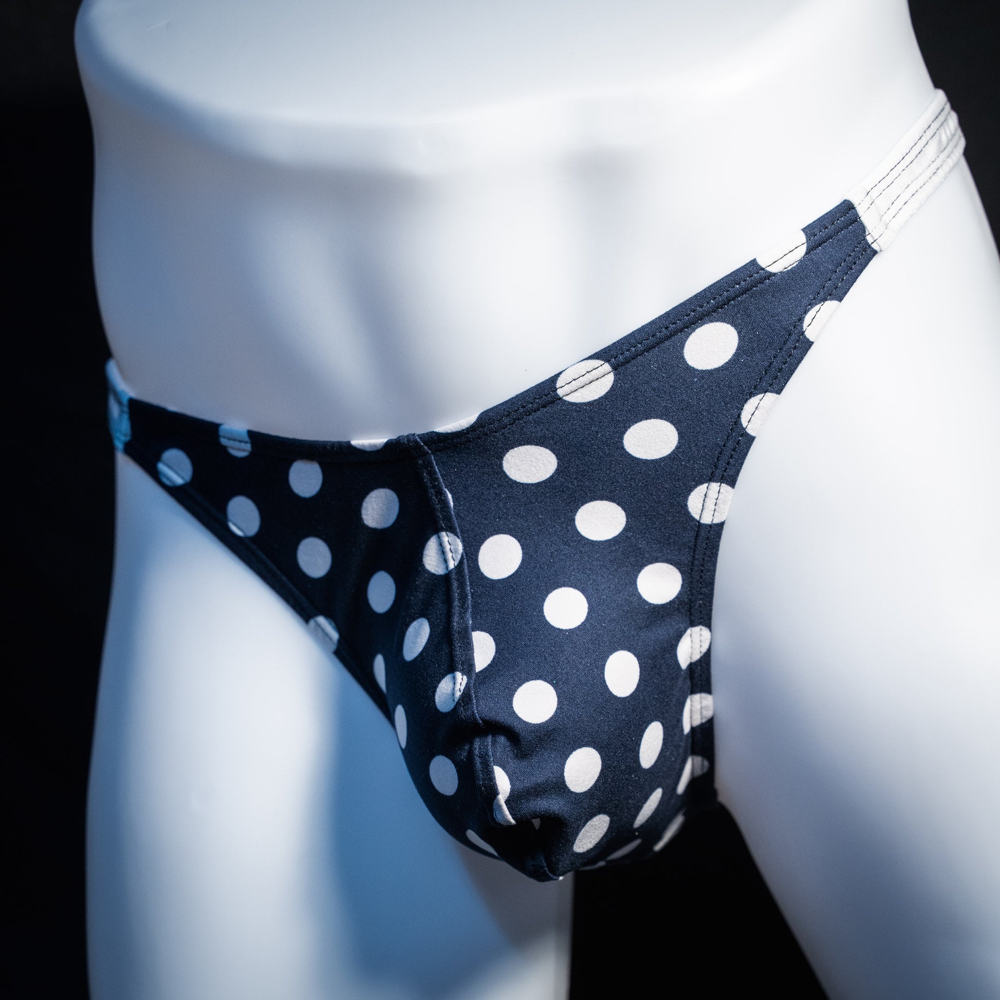 Men's navy blue and white thong underwear, classic cut, front view.