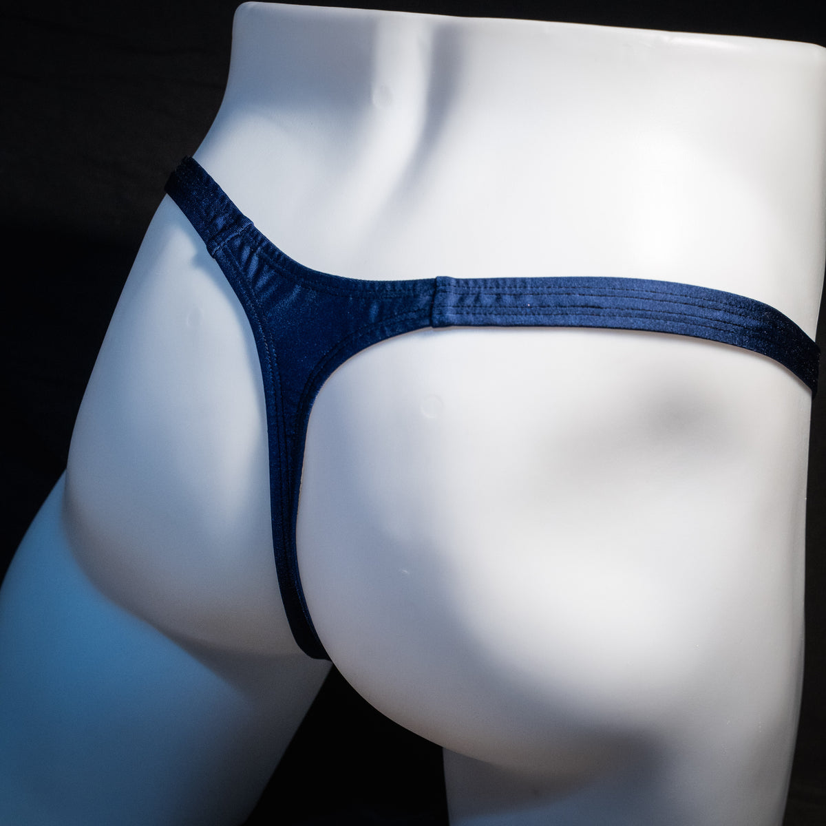 Men's navy blue thong underwear, classic cut, rear view.