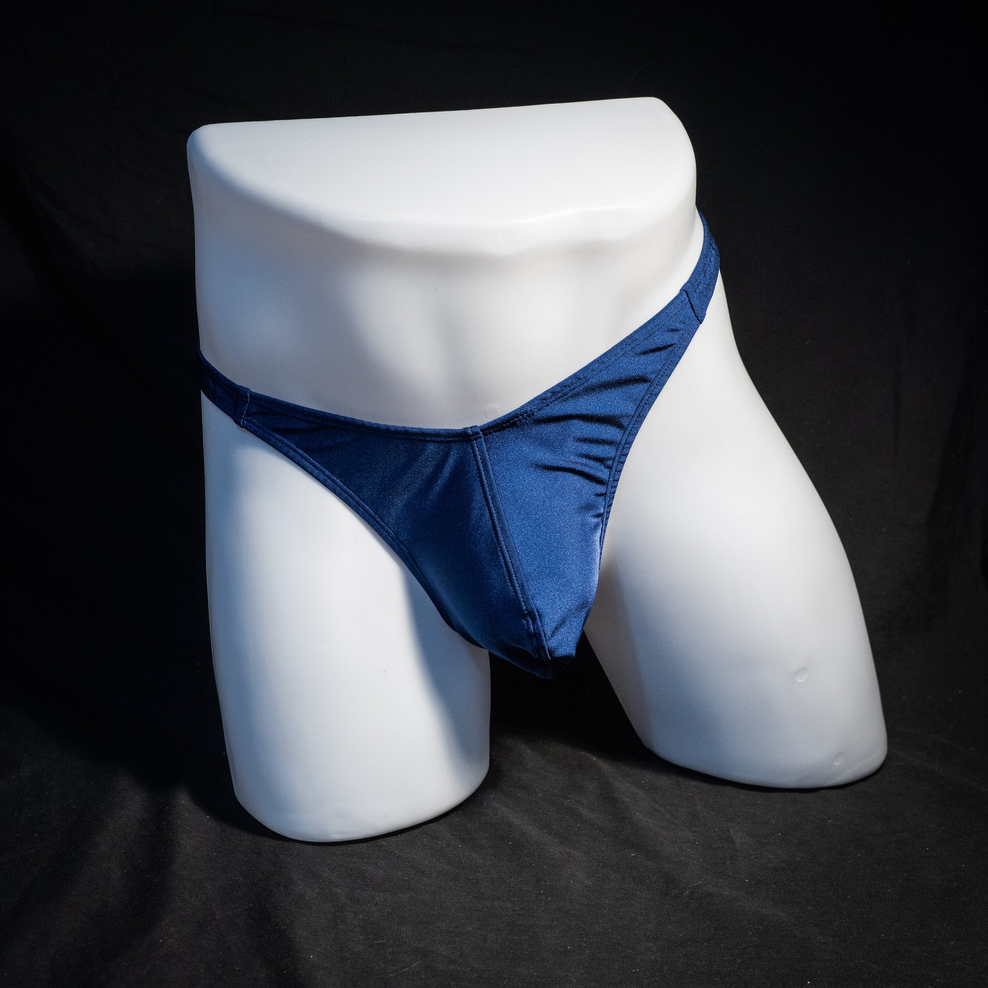 Men's navy blue thong underwear, classic cut, front view.
