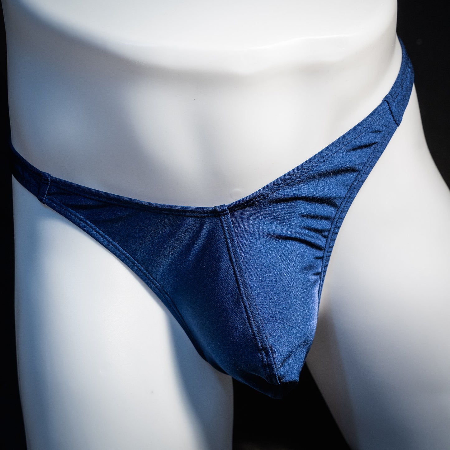 Men's navy blue thong underwear, classic cut, front view.