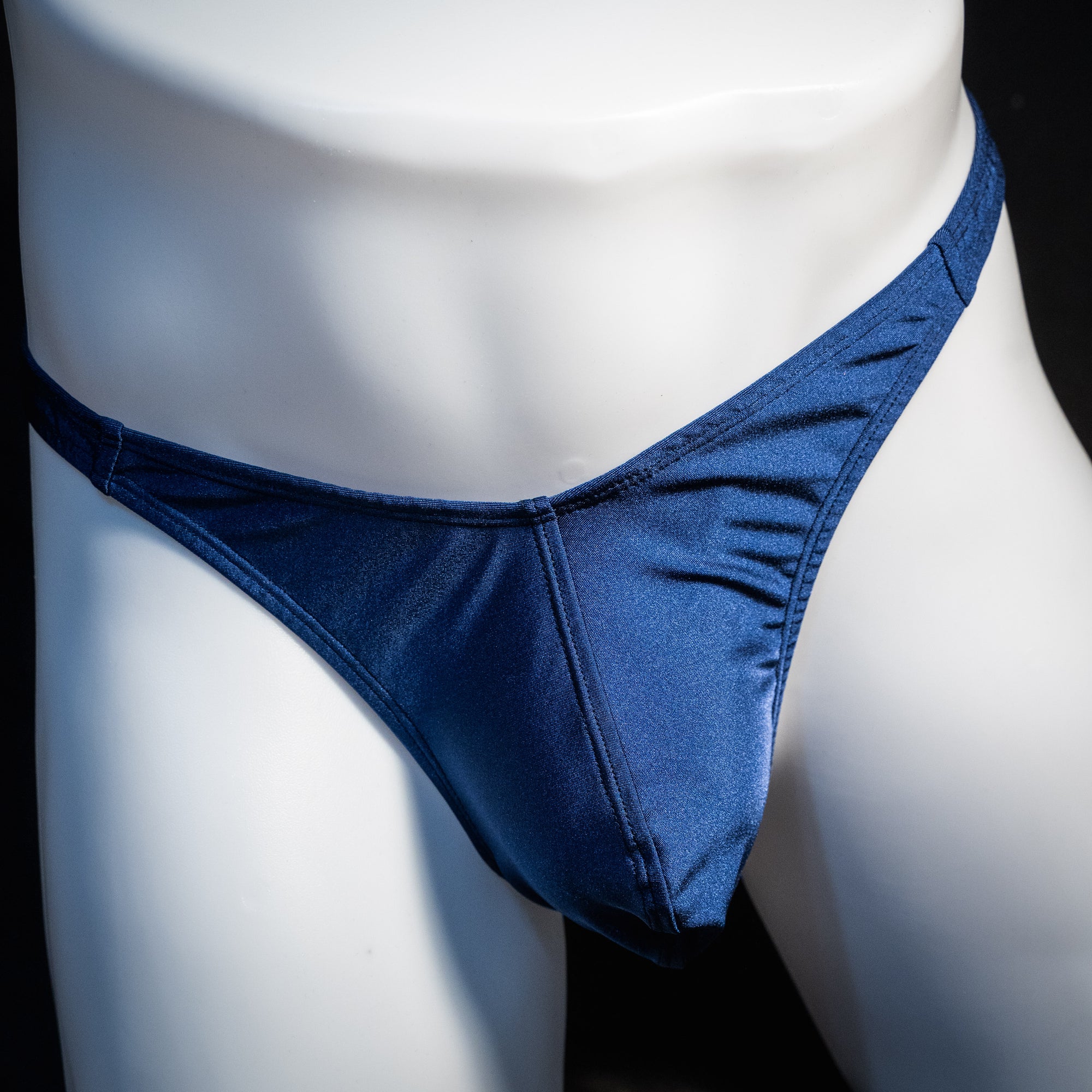 Men's navy blue thong underwear, classic cut, front view.