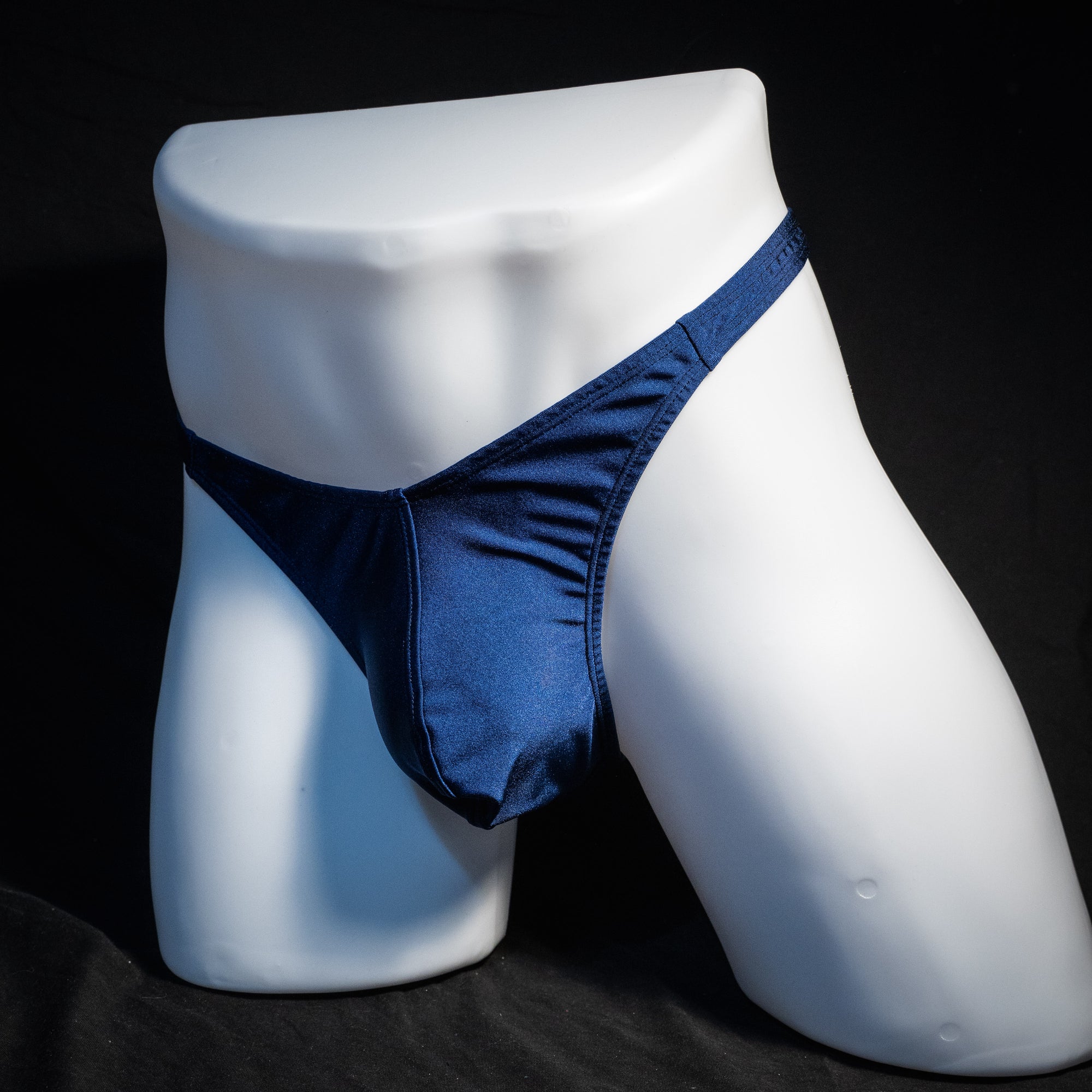 Men's navy blue thong underwear, classic cut, front view.