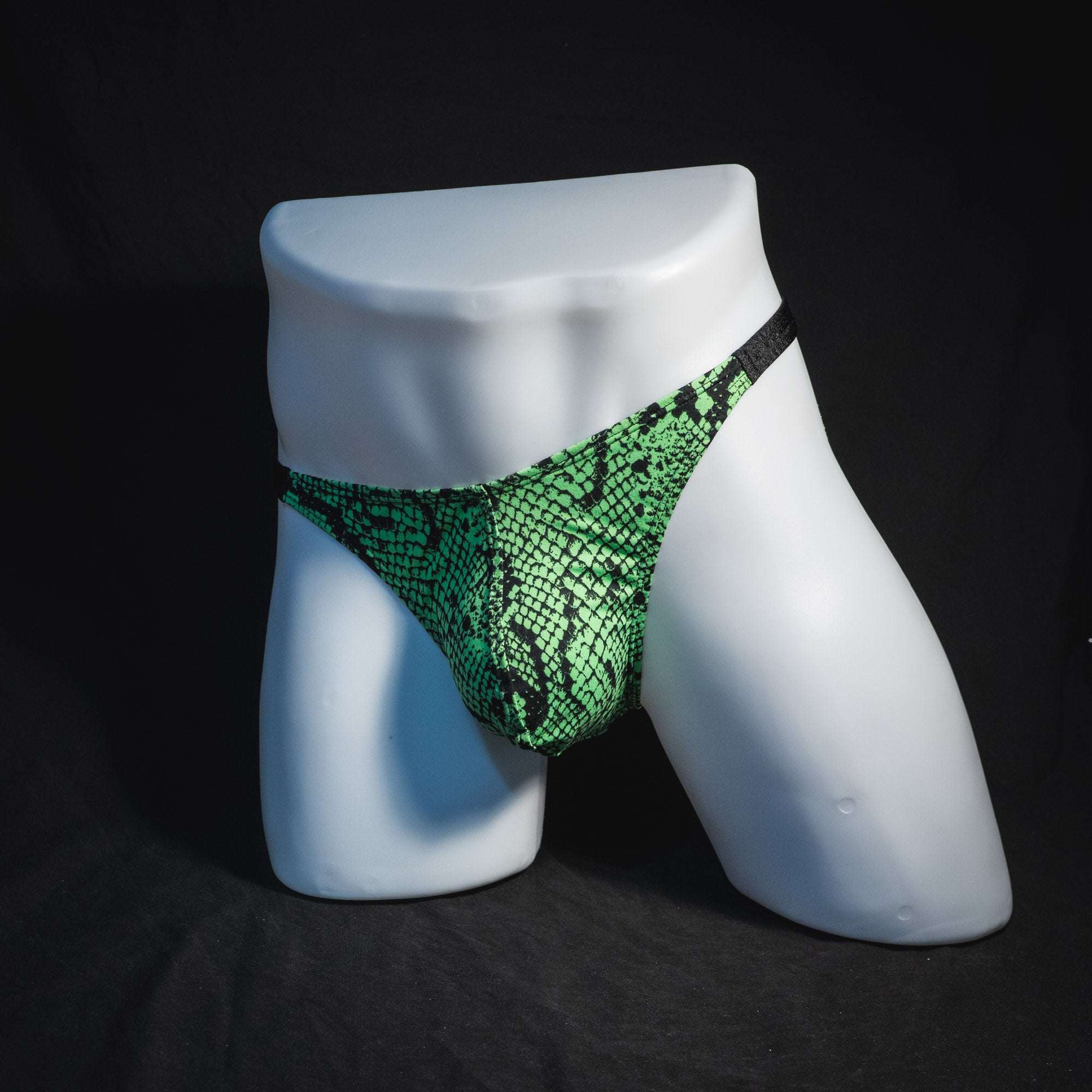 Men's neon green snakeskin thong underwear, classic cut, full angled front view.