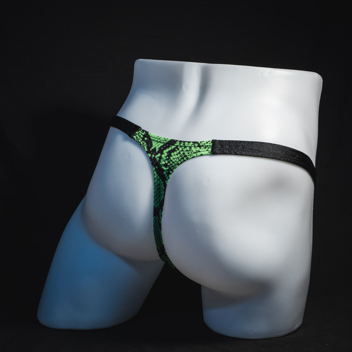 Men's neon green snakeskin thong underwear, classic cut, full angled rear view.