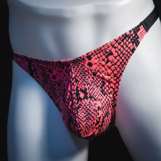 Men's neon pink snakeskin thong underwear, classic cut, angled front view.