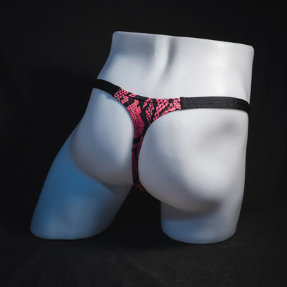 Men's neon pink snakeskin thong underwear, classic cut, full angled rear view.
