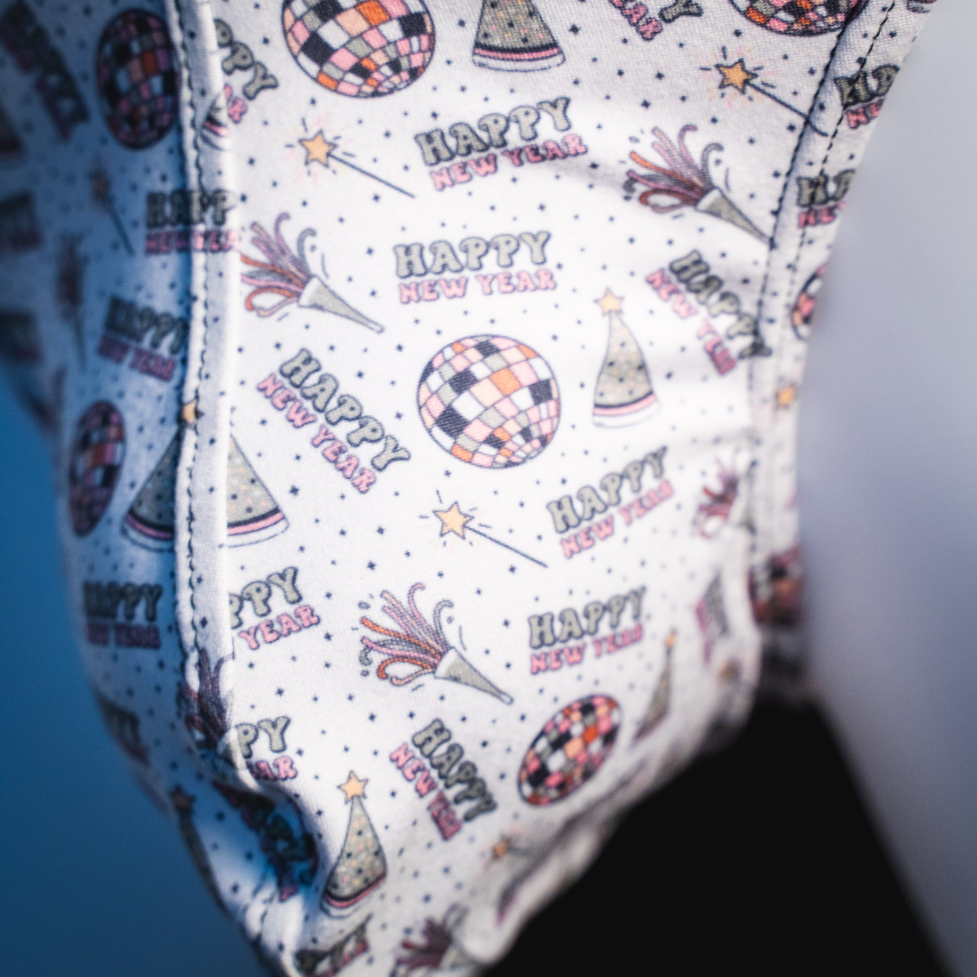 Men's new years thong underwear with shiny purple straps, classic cut, close up.