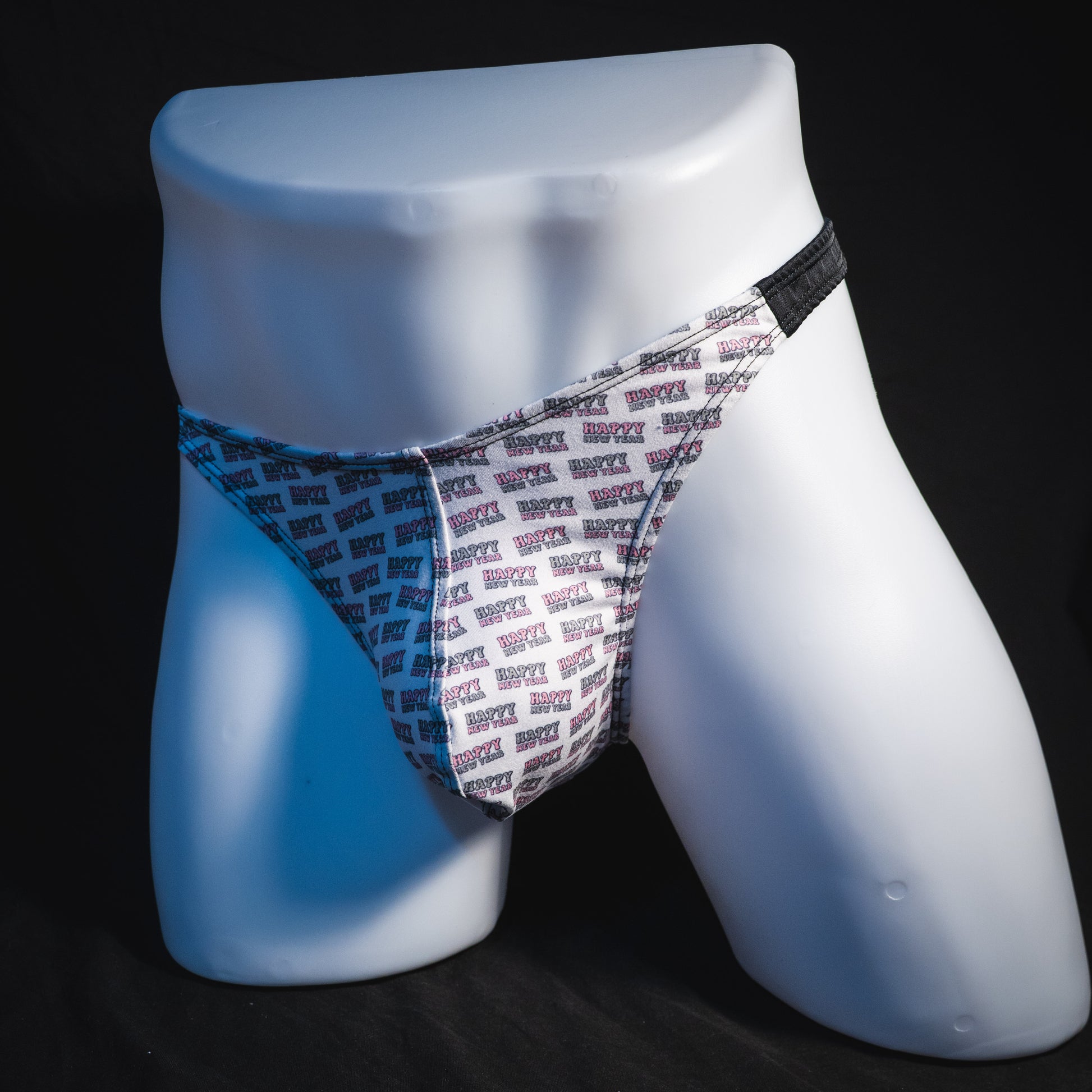 Men's new years thong underwear with black straps, classic cut, angled full front view.