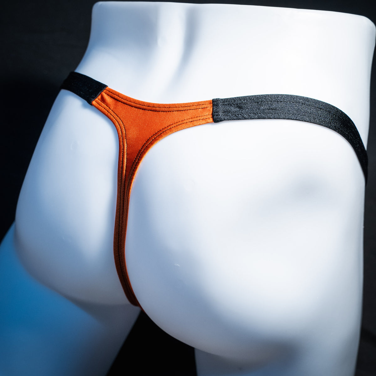 Men's orange and black Halloween thong underwear, classic cut, rear view.