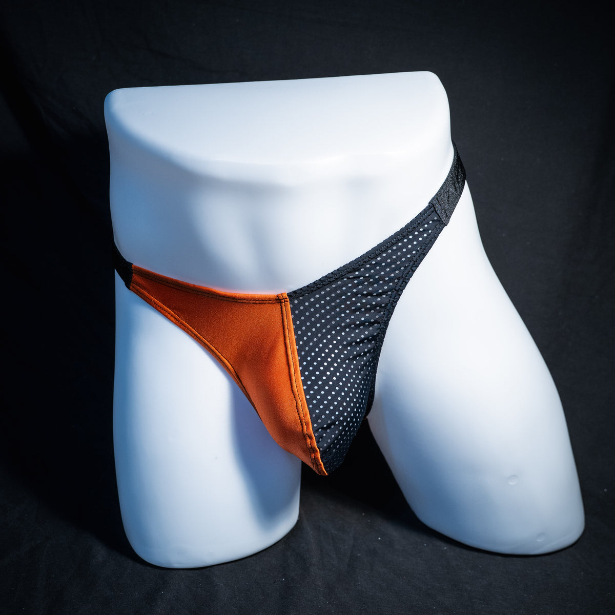 Men's orange and black Halloween thong underwear, classic cut, front view.
