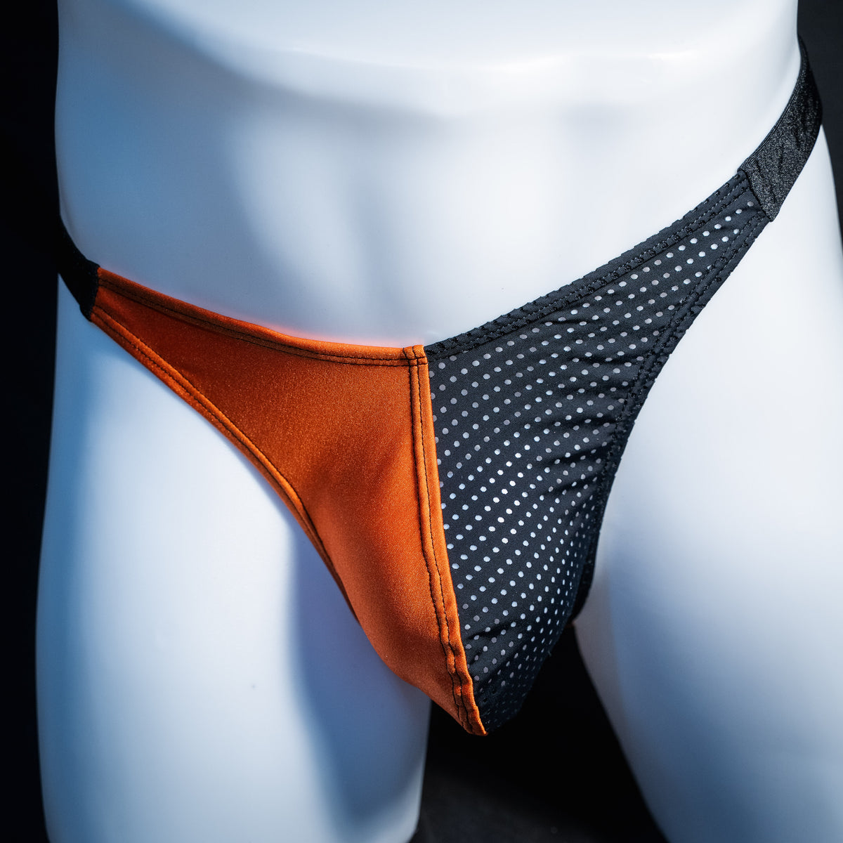 Men's orange and black Halloween thong underwear, classic cut, front view.