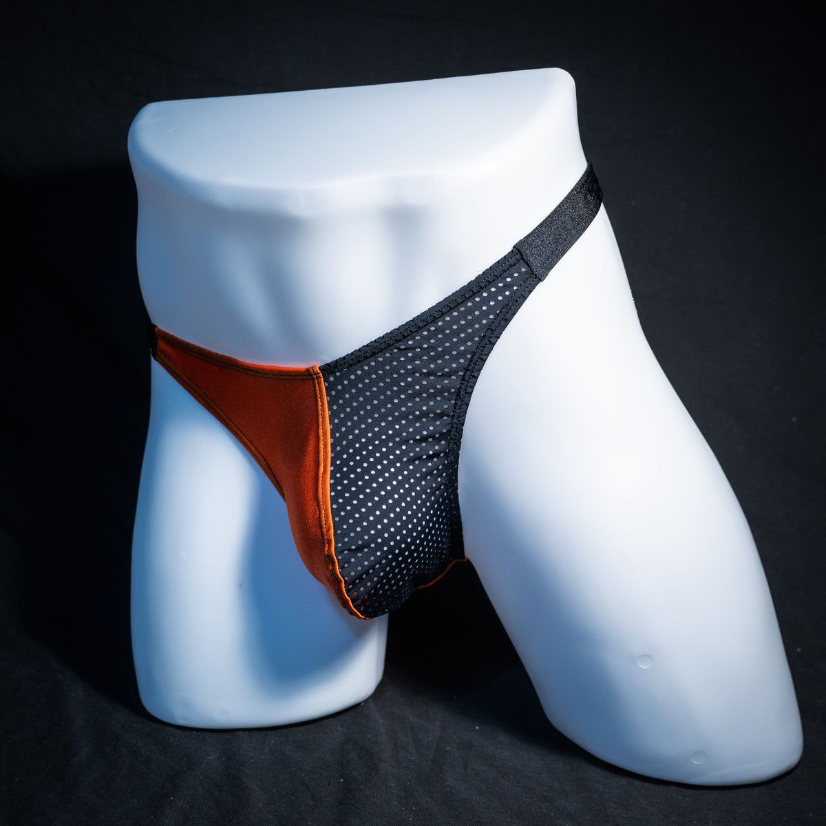 Men's orange and black Halloween thong underwear, classic cut, front view.