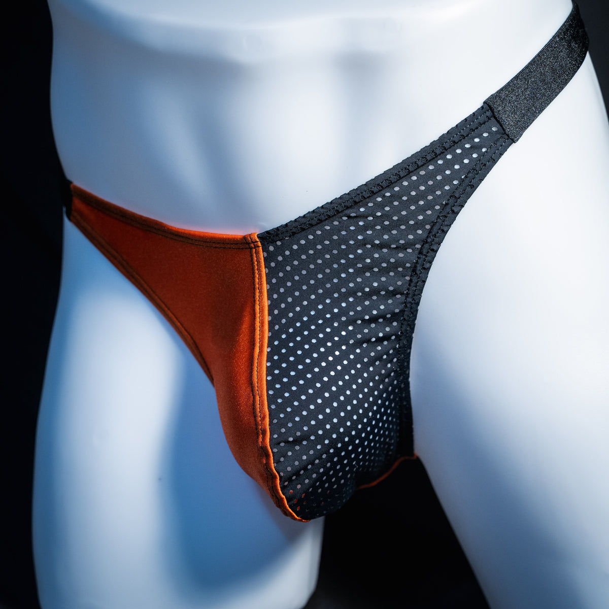 Men's orange and black Halloween thong underwear, classic cut, front view.