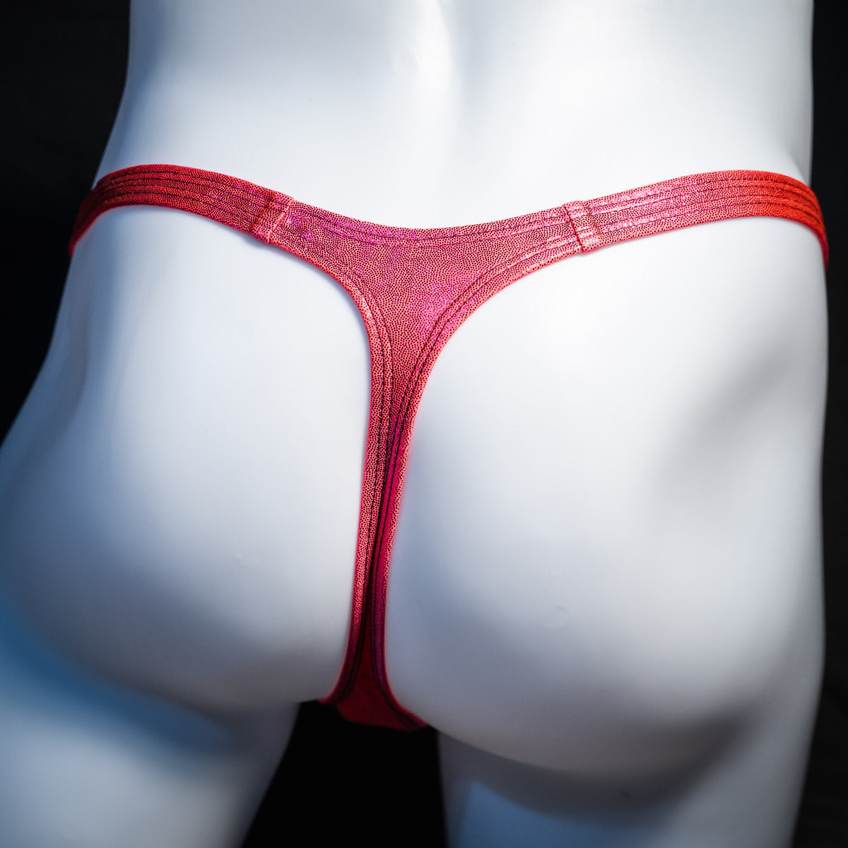 Men's orange fuchsia metallic thong underwear, classic cut, rear view.