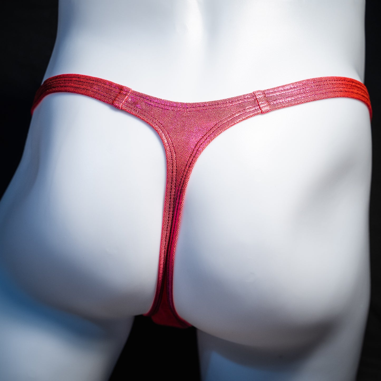Men's orange fuchsia metallic thong underwear, classic cut, rear view.
