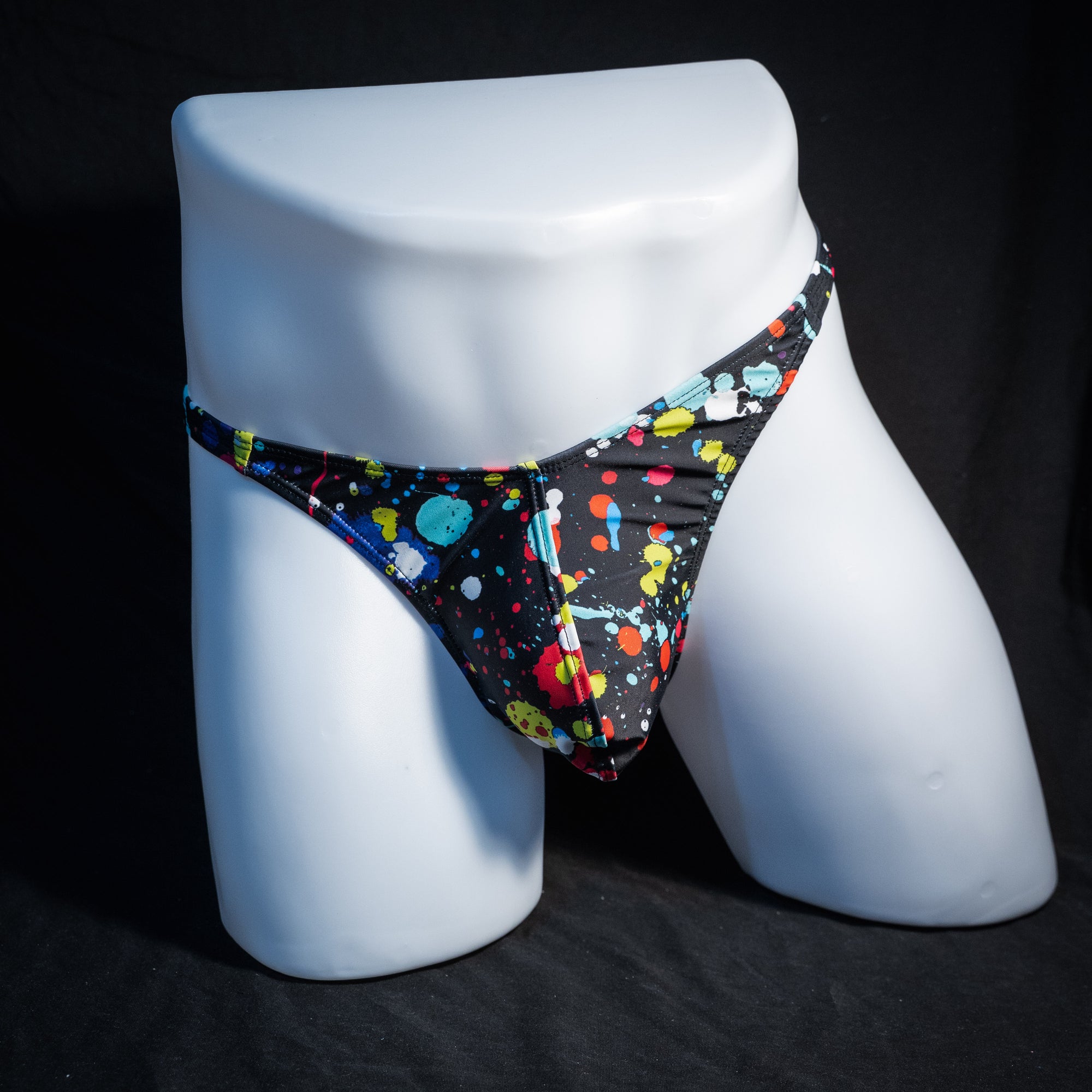 Men's paint splatter thong underwear, classic cut, front view.